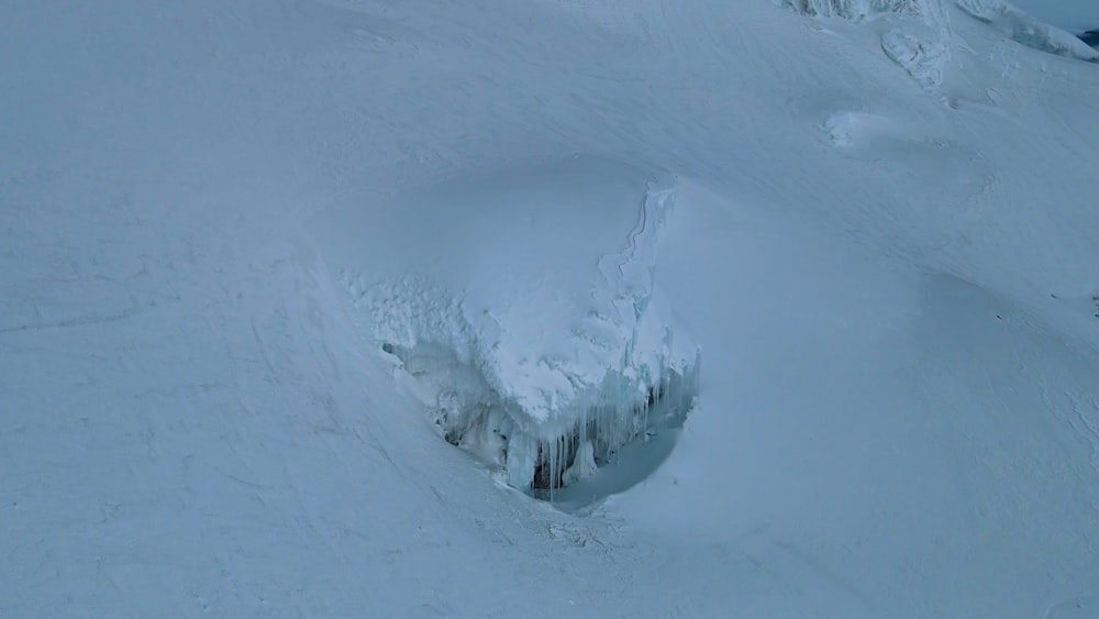 a man riding skis down a snow covered slope