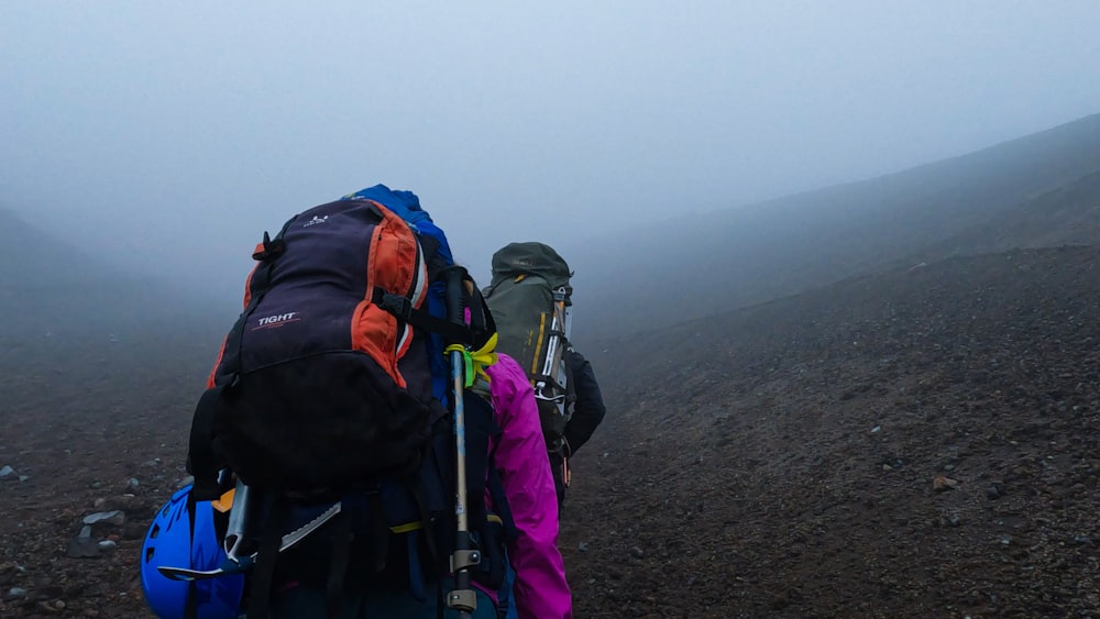 a couple of backpacks that are on a hill