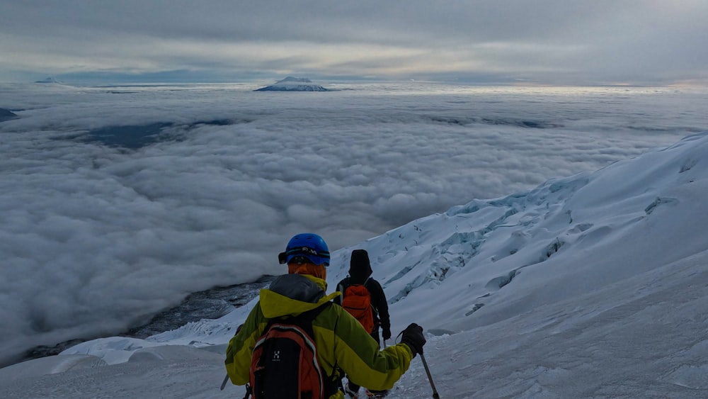 a man standing on top of a snow covered slope