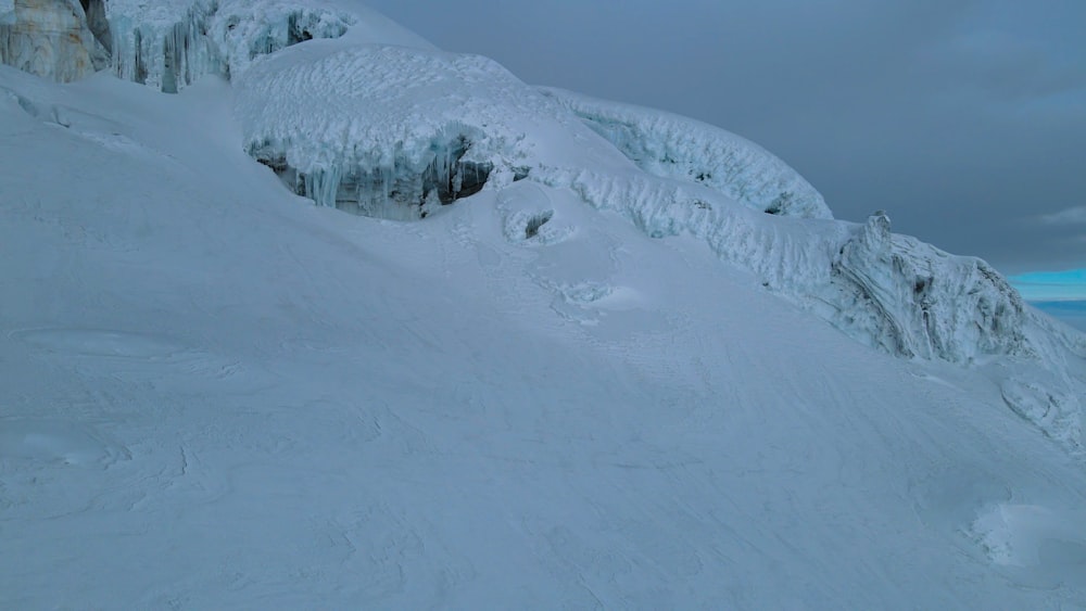 a man riding skis down a snow covered slope