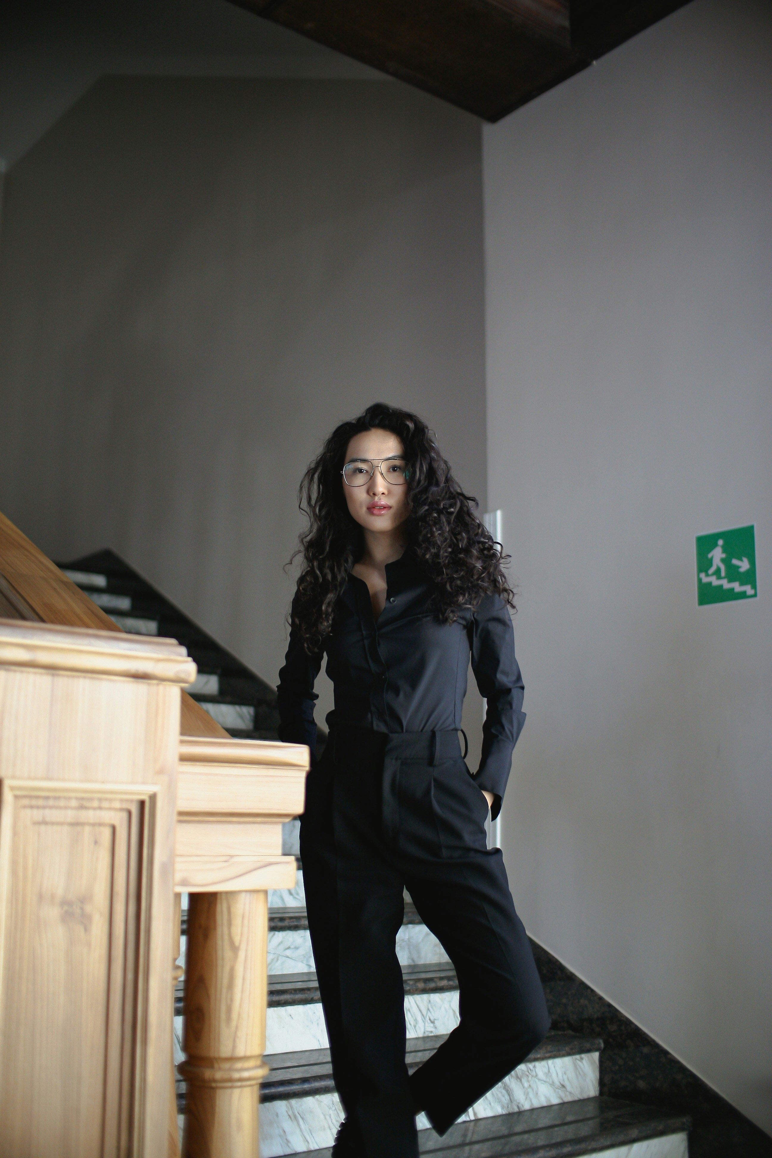 a woman standing on the stairs of a building