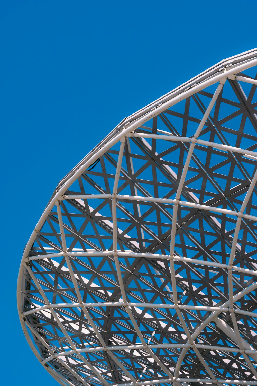 a large metal structure sitting under a blue sky
