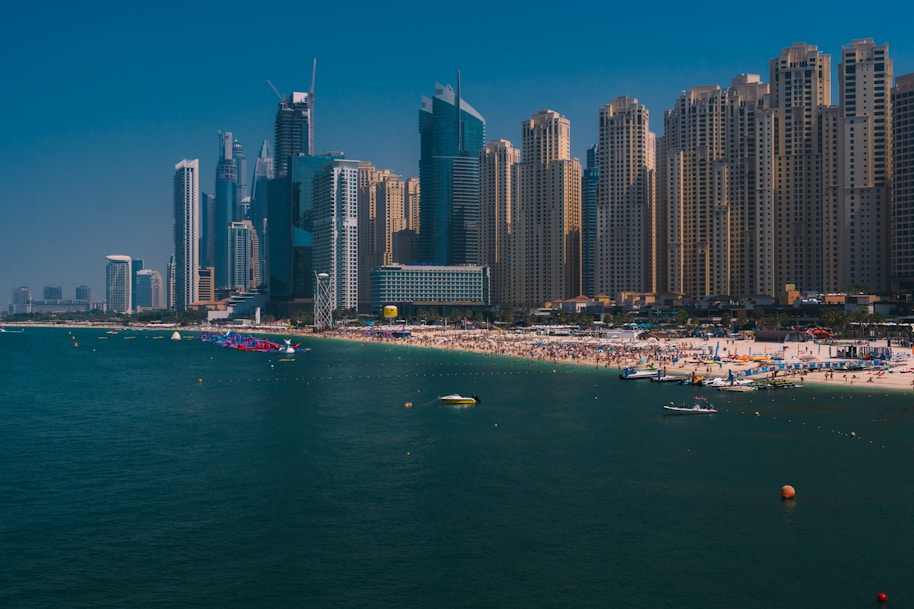 a beach in front of a city with tall buildings