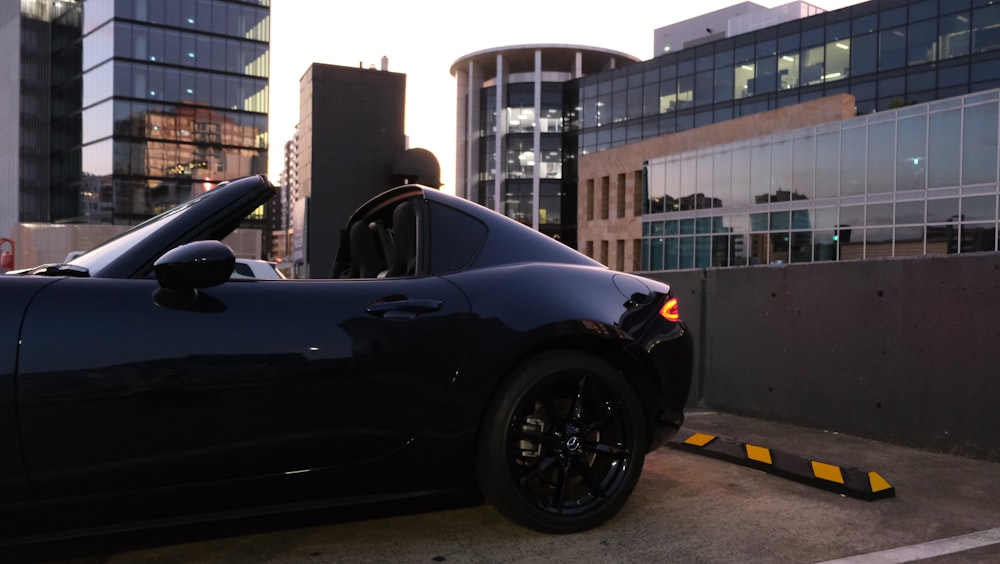 a black sports car parked in a parking lot