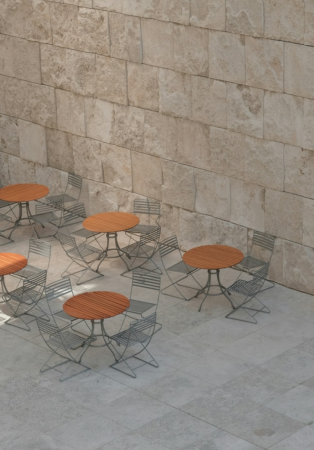 a group of tables sitting on top of a stone floor