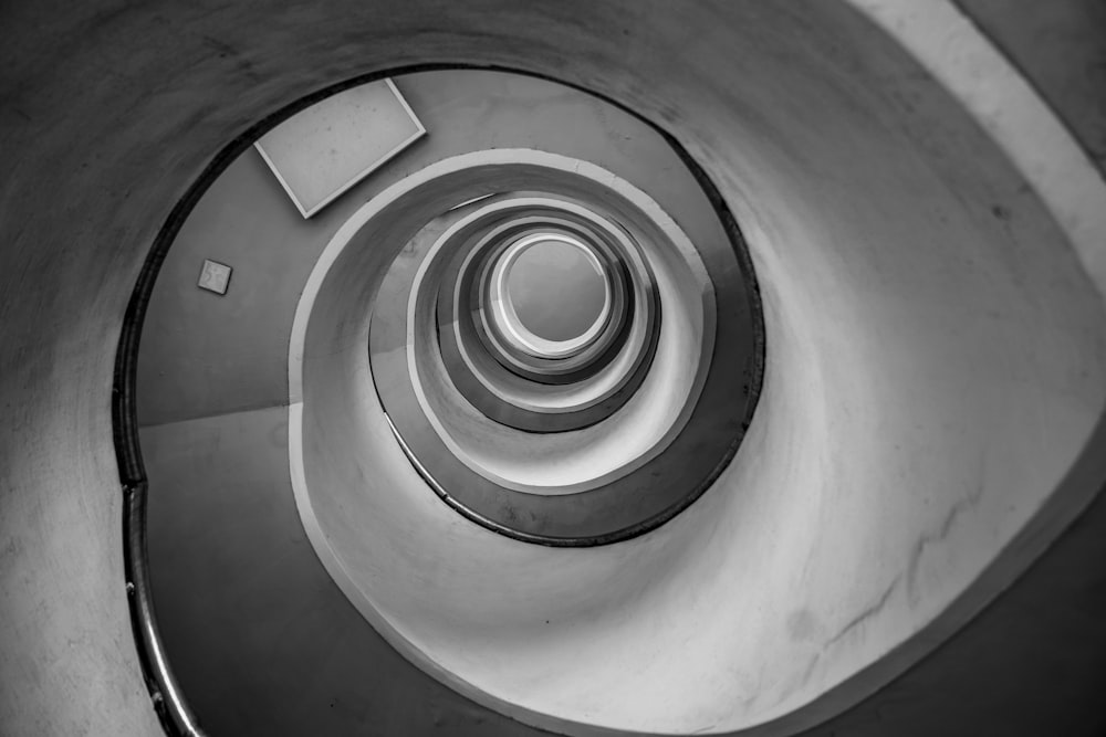 a black and white photo of a spiral staircase