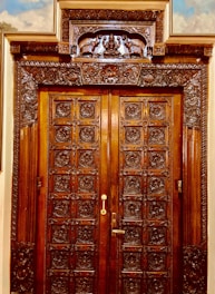 A beautifully crafted wooden door with intricate details and a polished finish.
