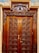 A beautifully restored wooden door with a polished finish, showcasing rich grain patterns and vibrant color.