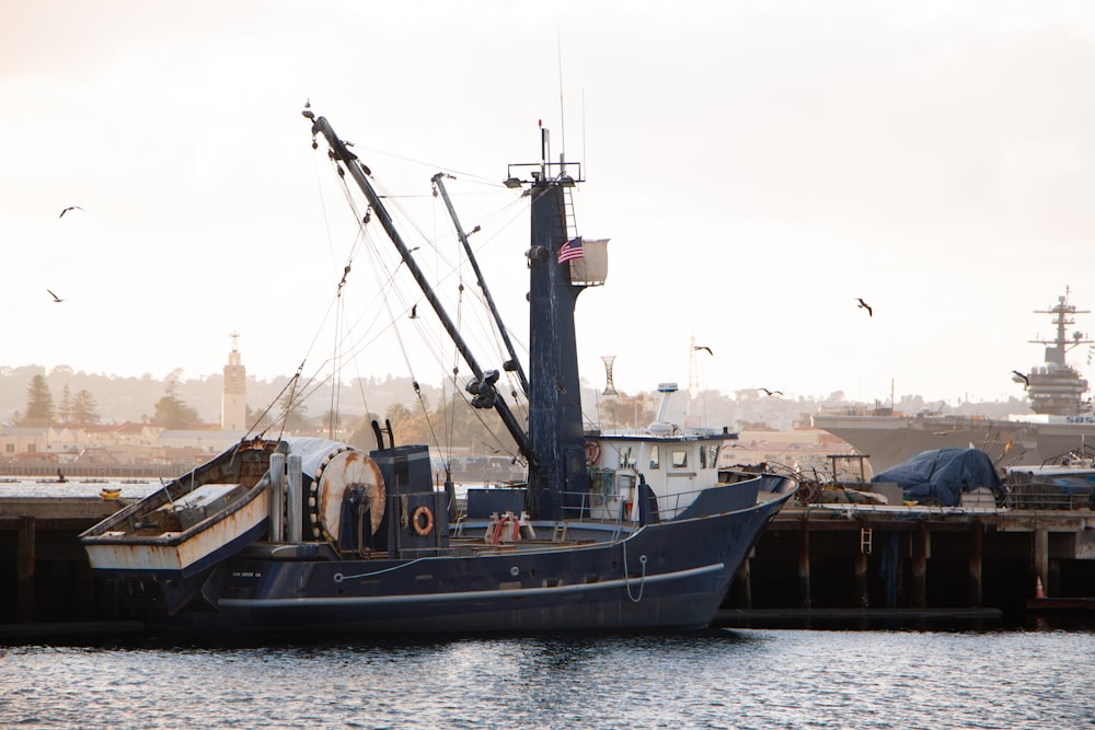 a boat is docked in the water near a dock