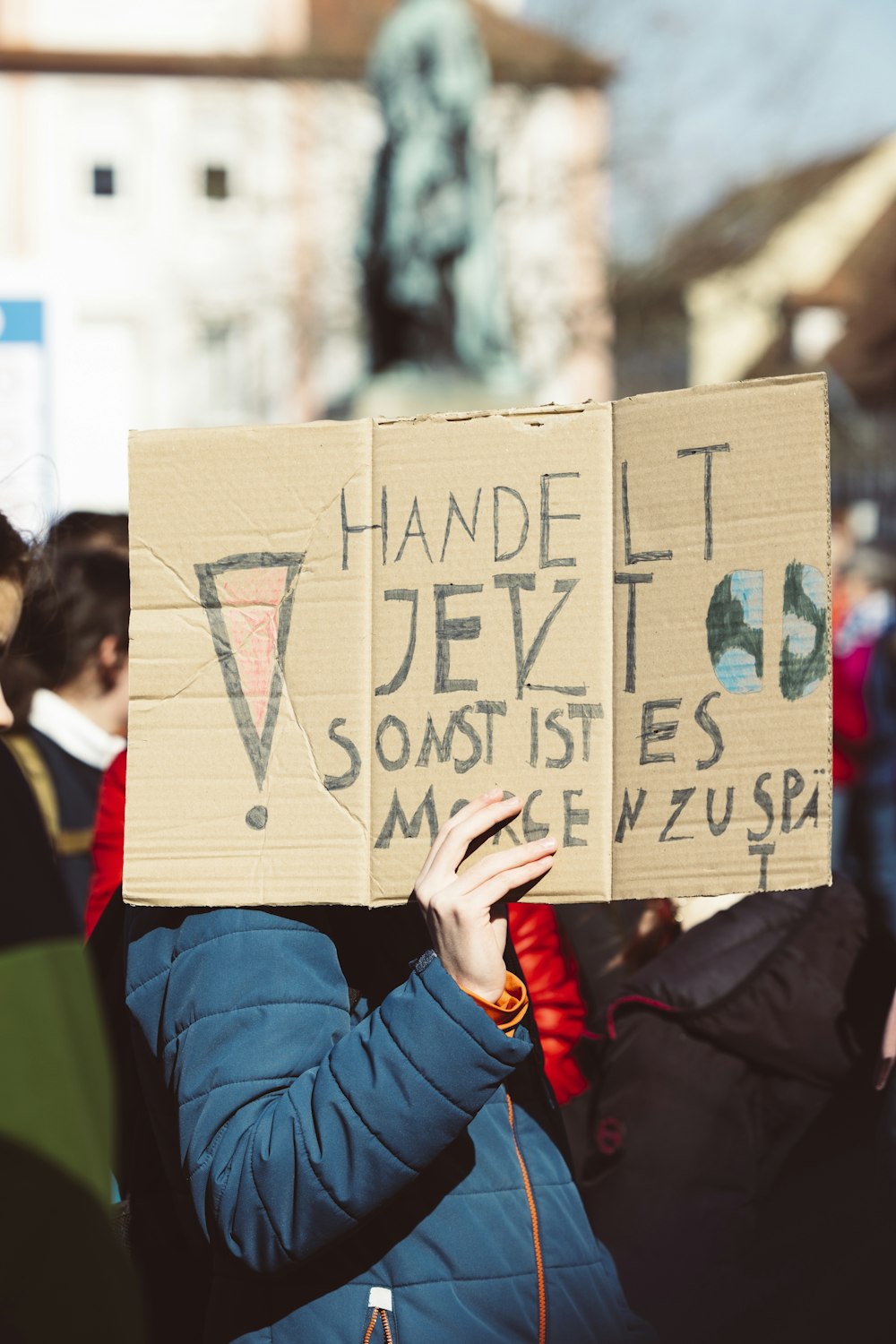 a person holding a sign that says handle it