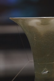 Close-up of a raw stoneware ceramic piece highlighting texture and subtle light reflections.