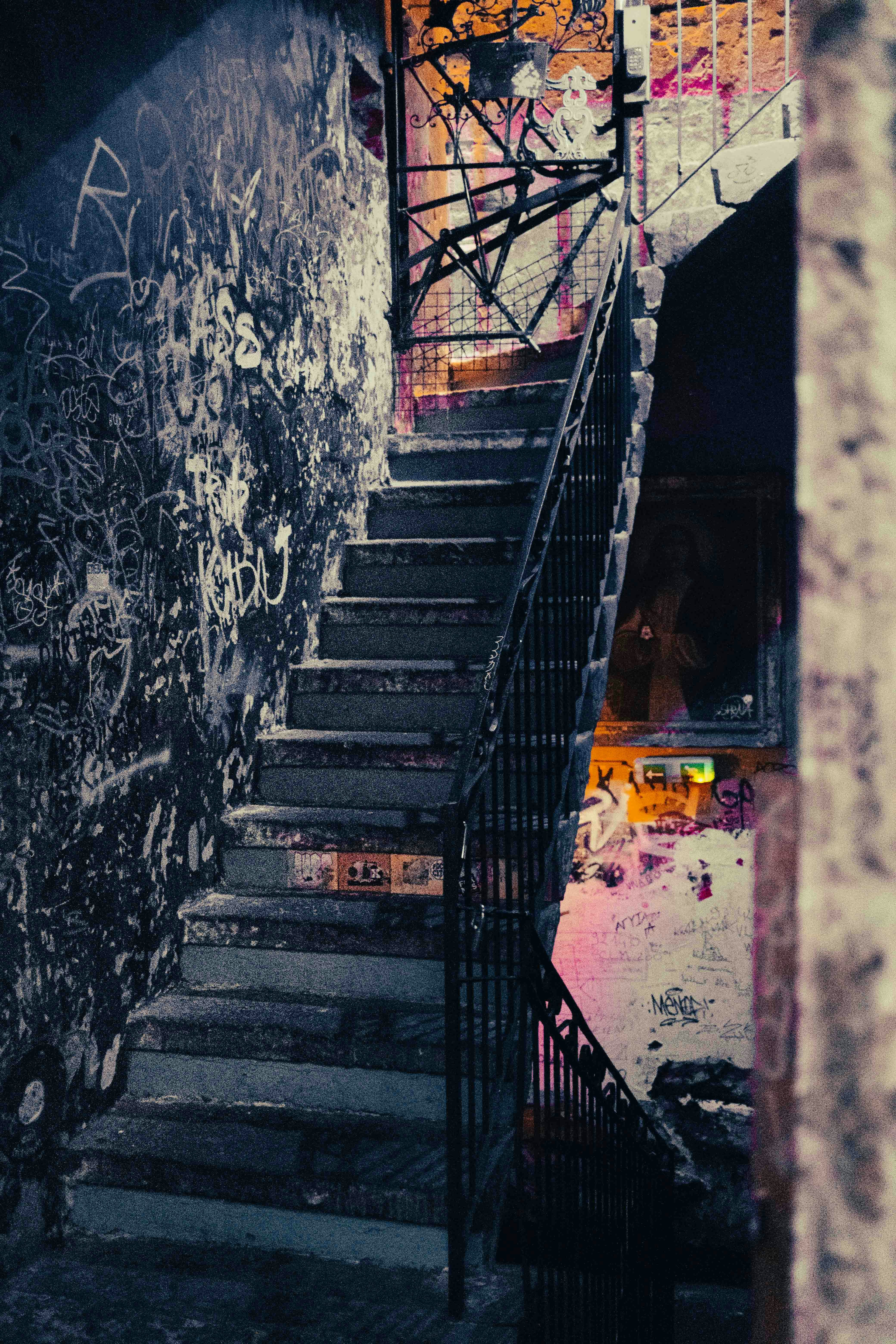a set of stairs leading up to a graffiti covered wall
