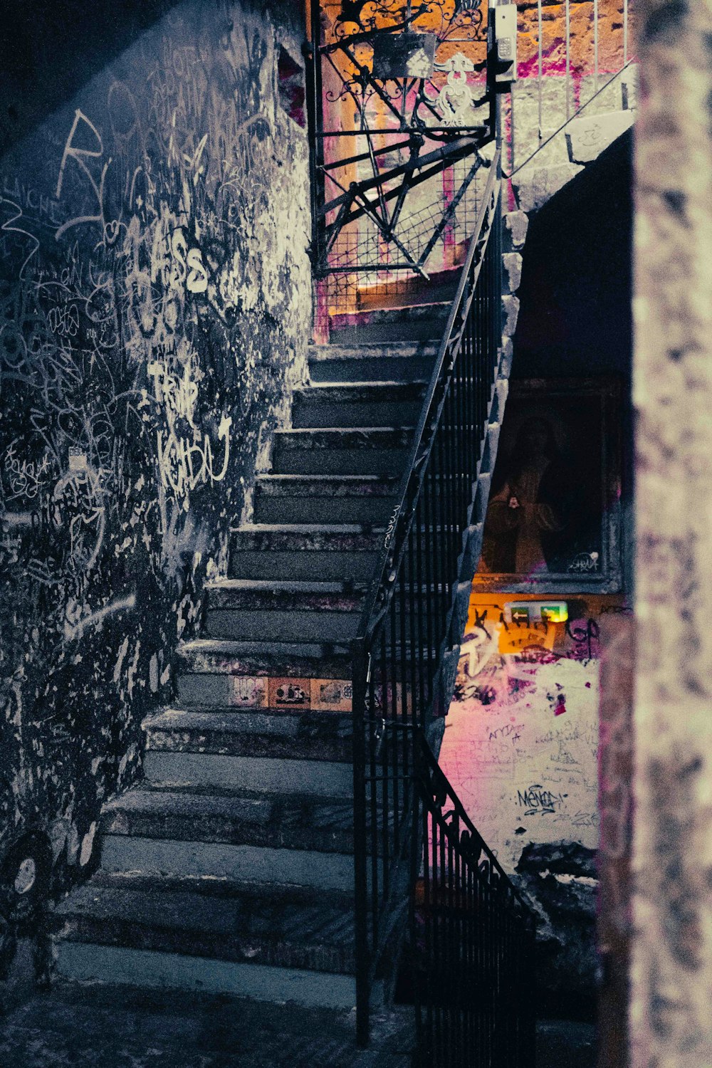 a set of stairs leading up to a graffiti covered wall