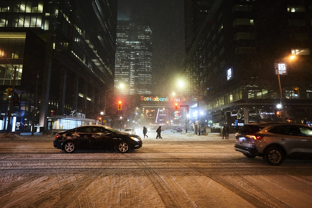 a couple of cars that are sitting in the snow