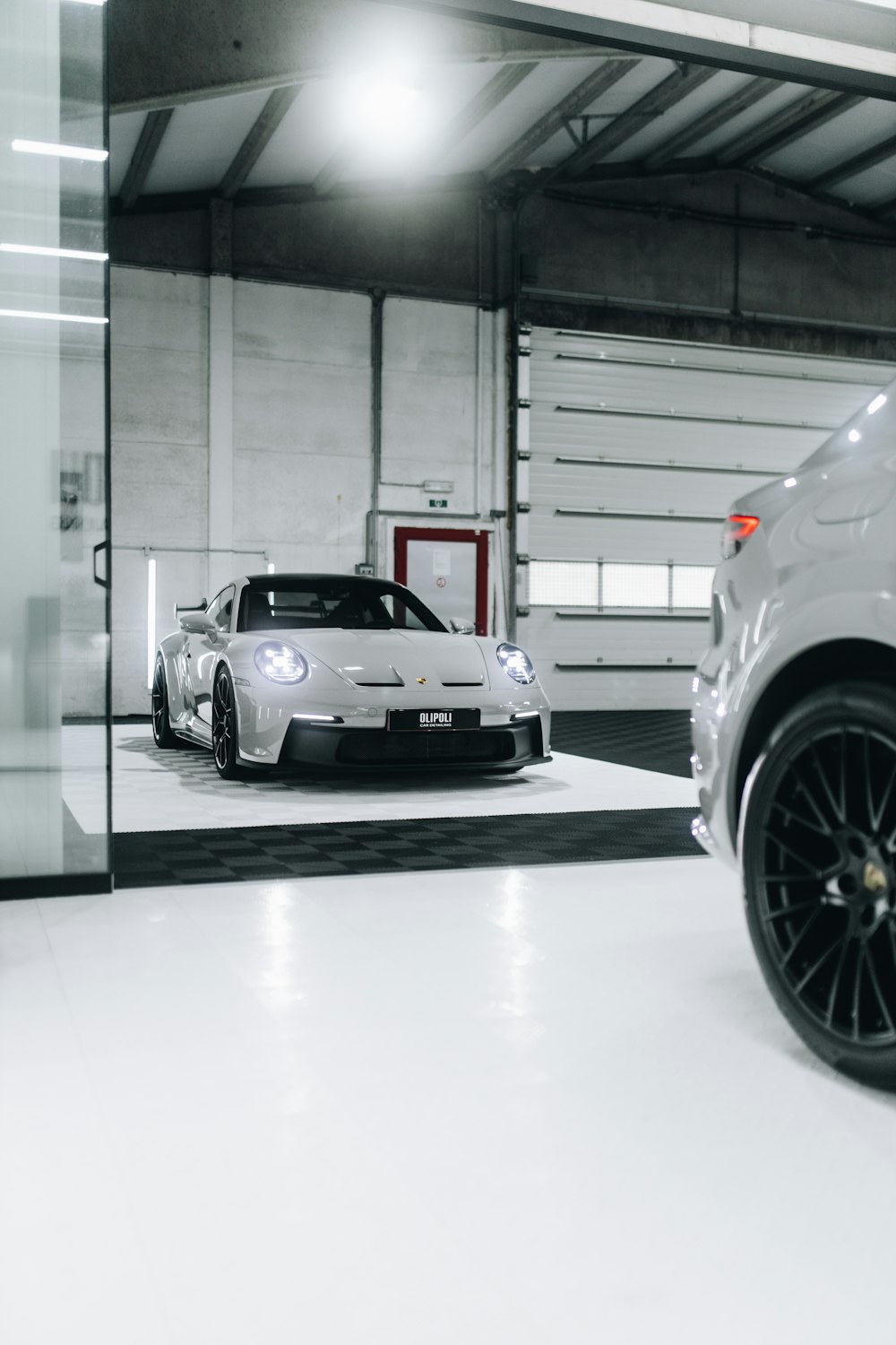 a white sports car parked in a garage