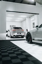 A modern garage workspace with sleek storage cabinets and a clean, neutral floor.