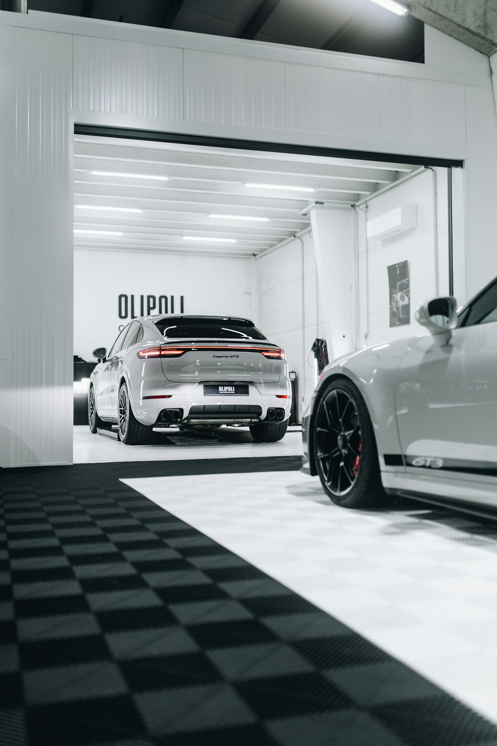 two cars parked in a garage next to each other