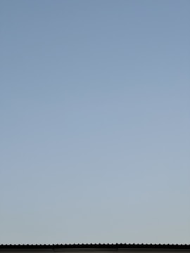 An insulated roof with clear blue skies above.