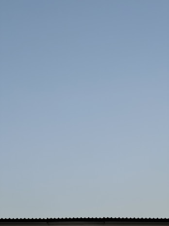 Finished waterproofed rooftop with a clear blue sky background.