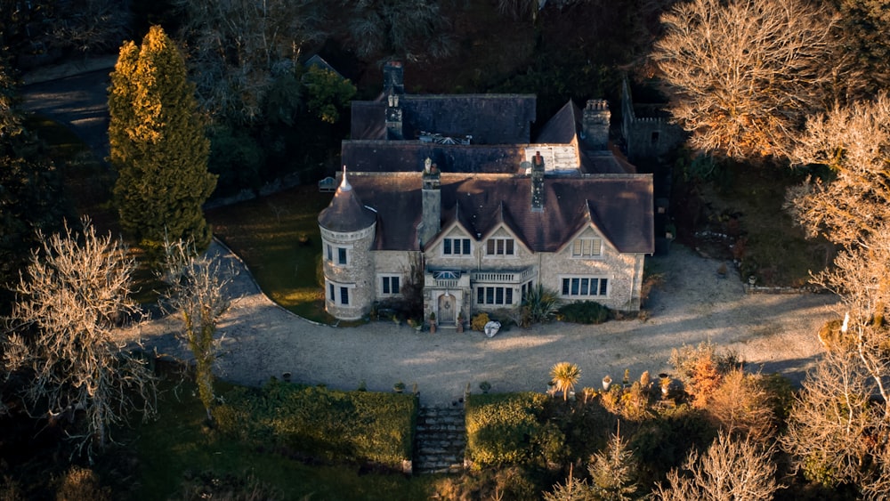 an aerial view of a large house surrounded by trees