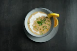 A bowl of creamy homemade soup garnished with herbs.