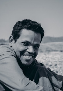 Close-up of a confident man smiling outdoors
