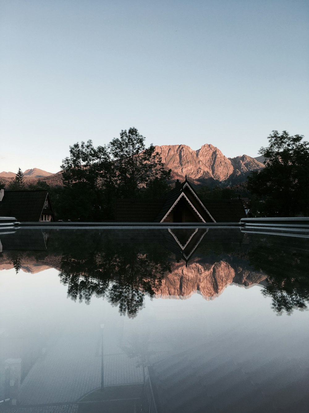 a reflection of a mountain in a pool of water