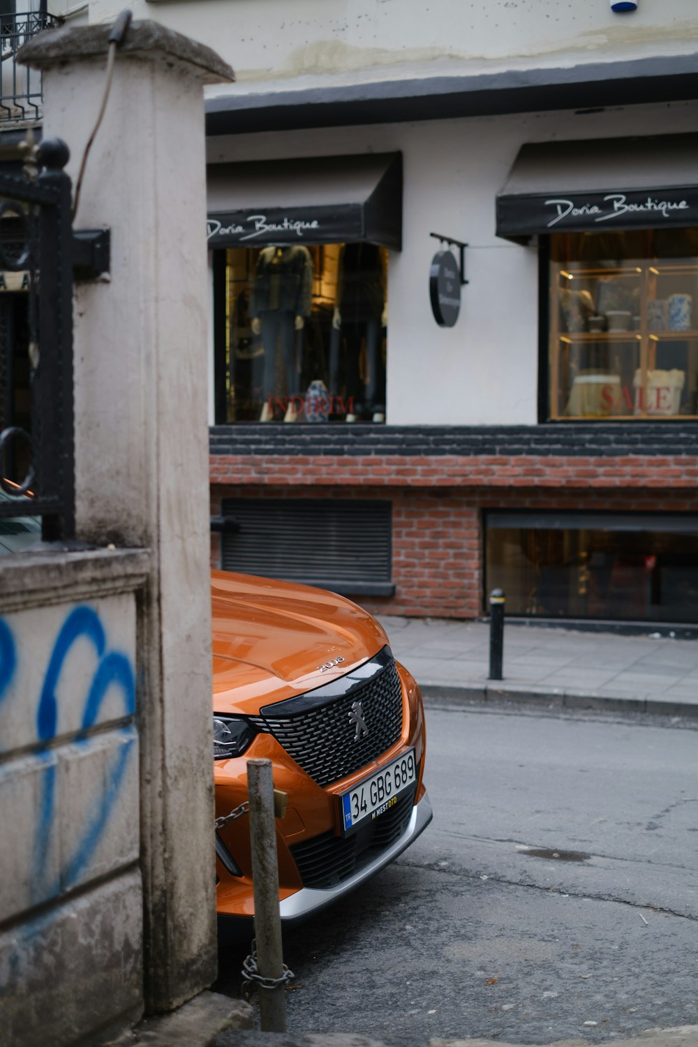 an orange car parked in front of a building