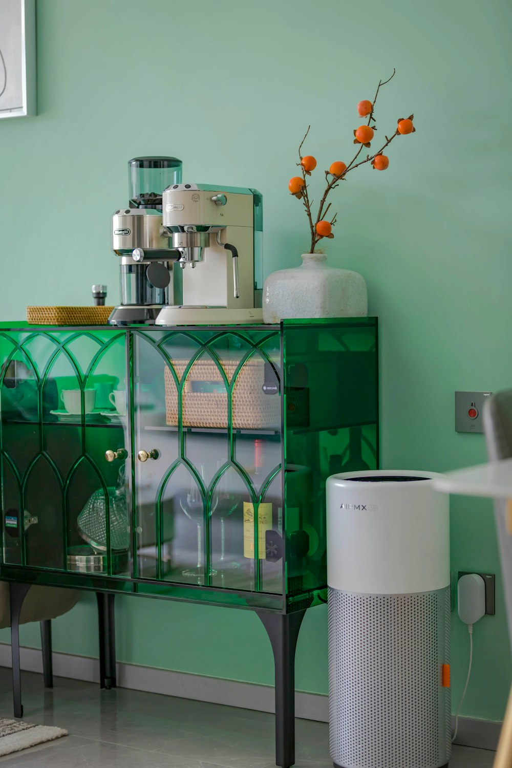 a room with a green cabinet and a white air conditioner