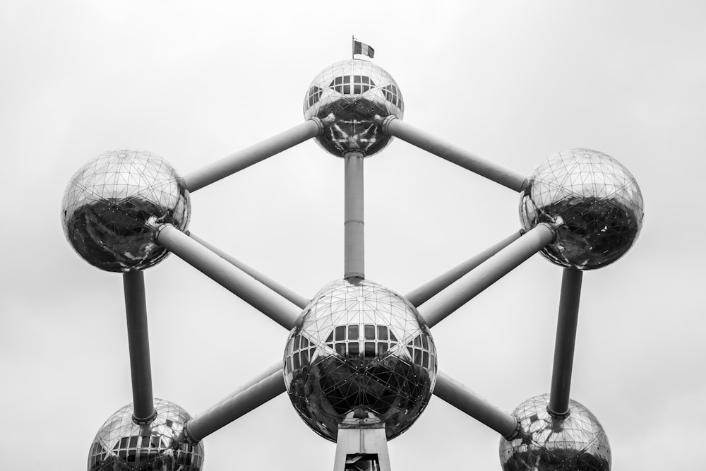 a black and white photo of a structure with mirrored balls