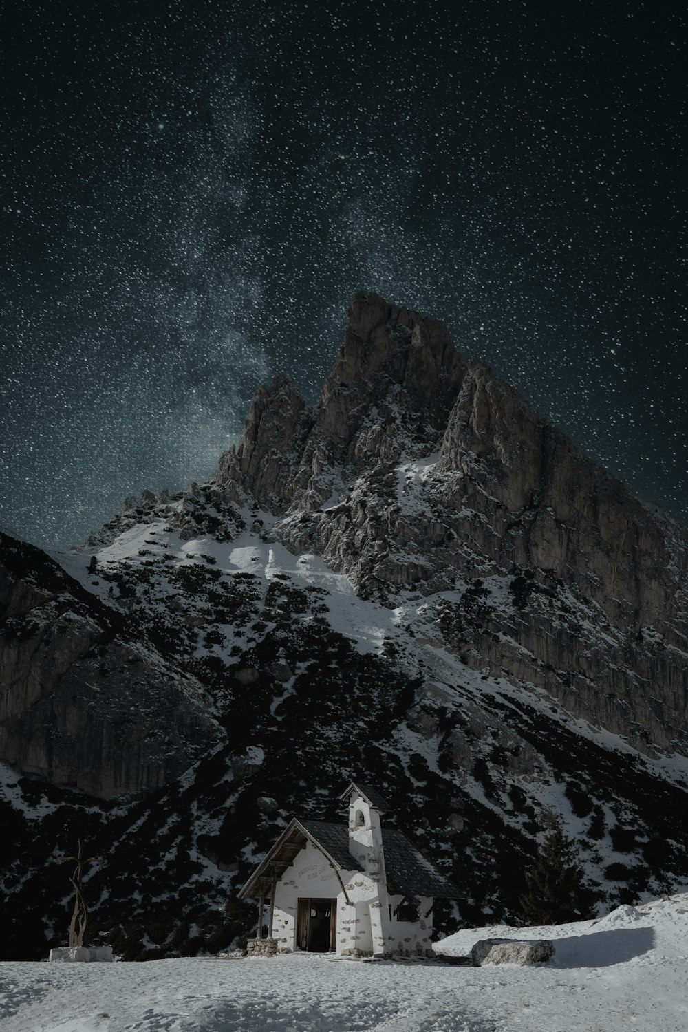 a house in the middle of a snowy mountain