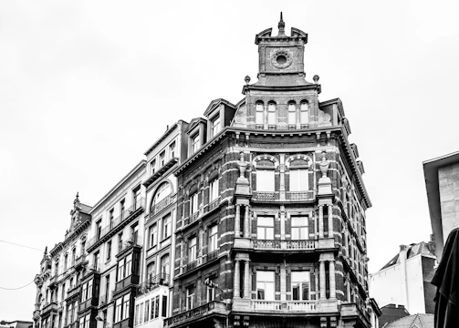 A black and white photograph of an intricate architectural detail on an old building.