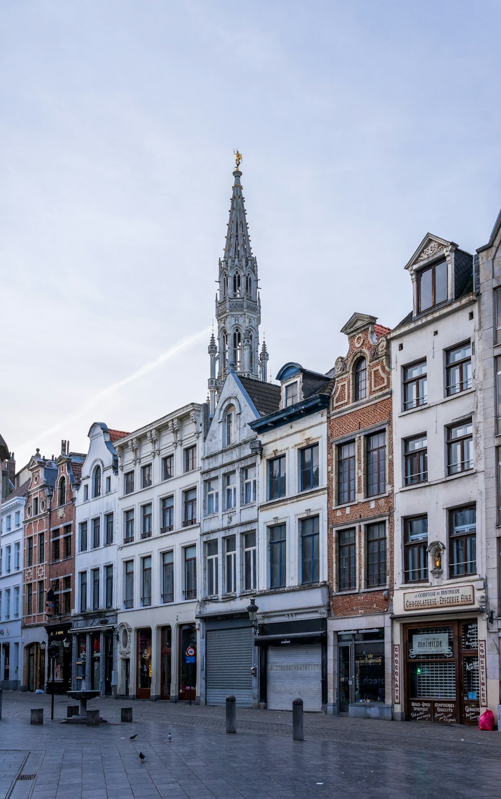 a row of buildings with a clock tower in the background