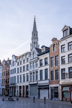 a row of buildings with a clock tower in the background