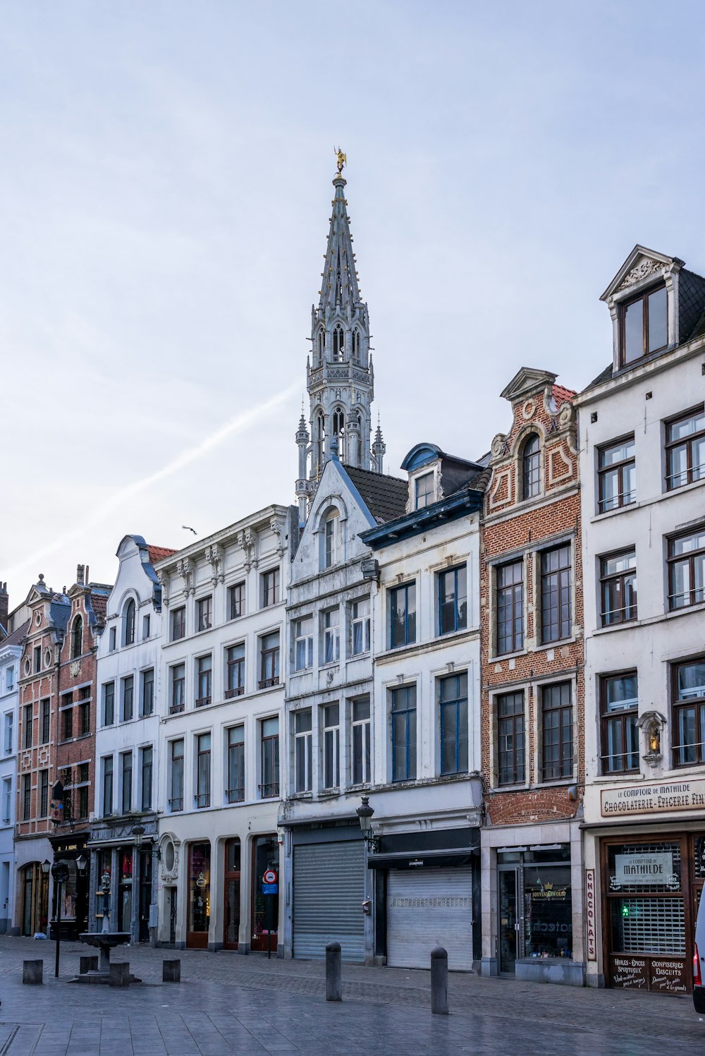 a row of buildings with a clock tower in the background