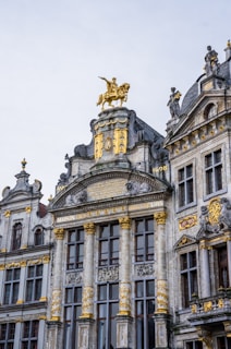 a large building with a golden statue on top of it