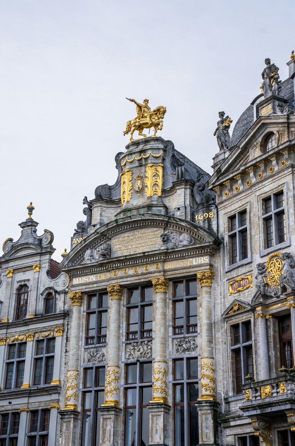 a large building with a golden statue on top of it