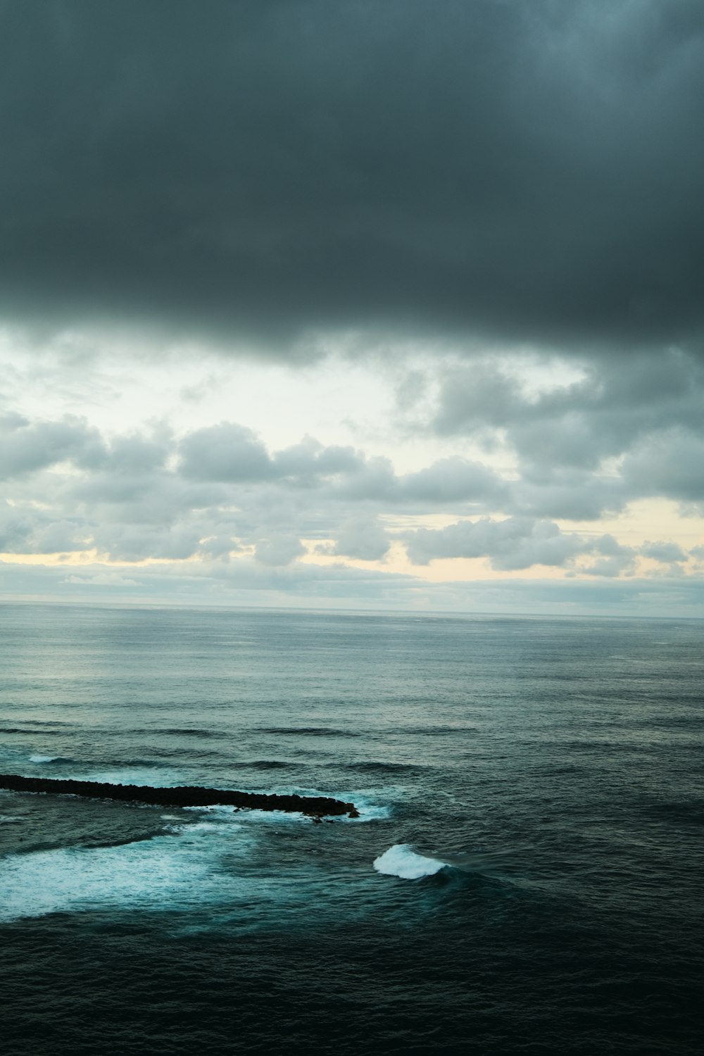 a large body of water under a cloudy sky