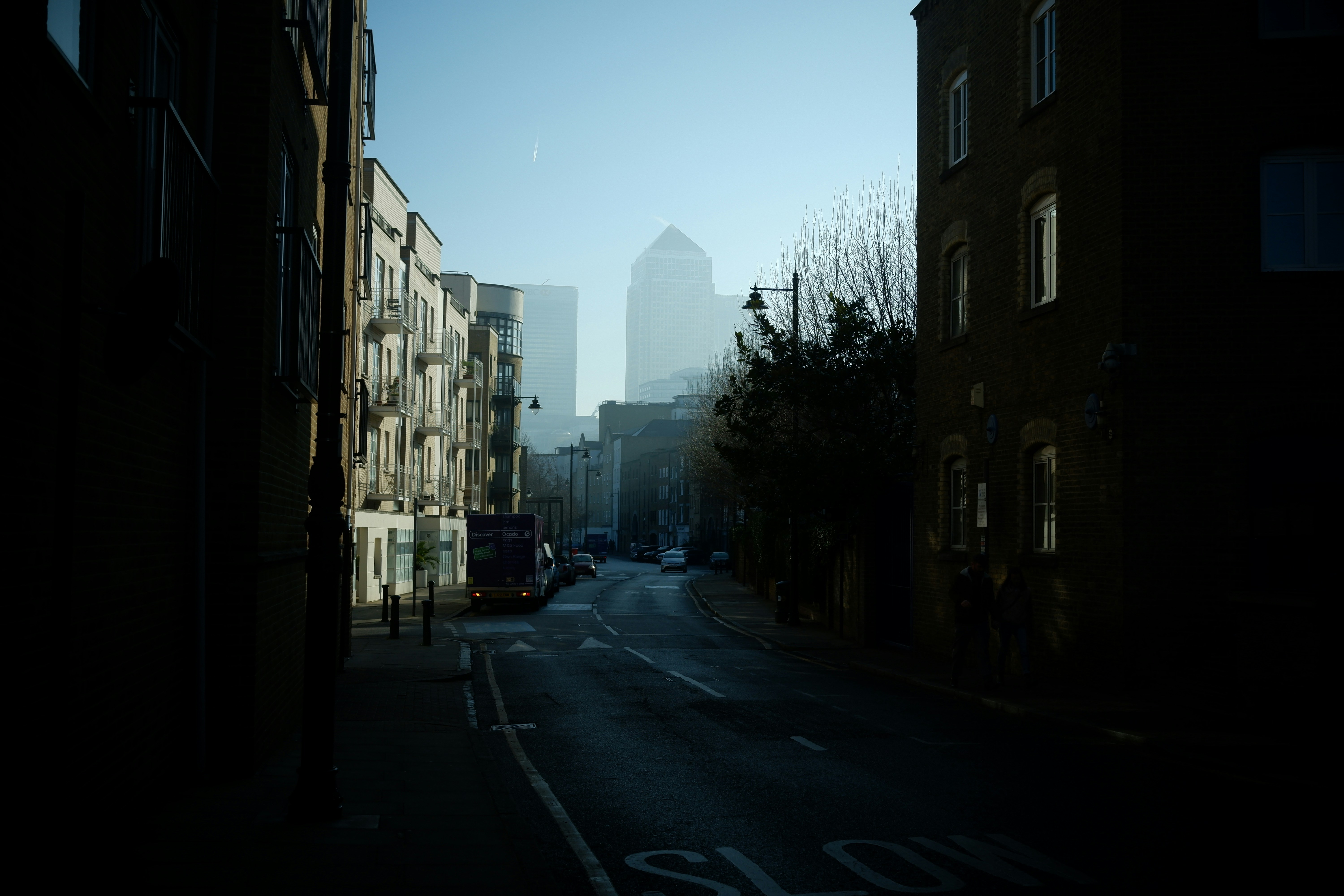 a city street with a bus on the side of it