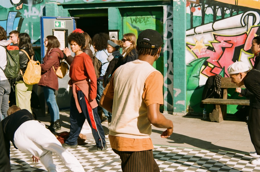 a group of people standing on a checkered floor