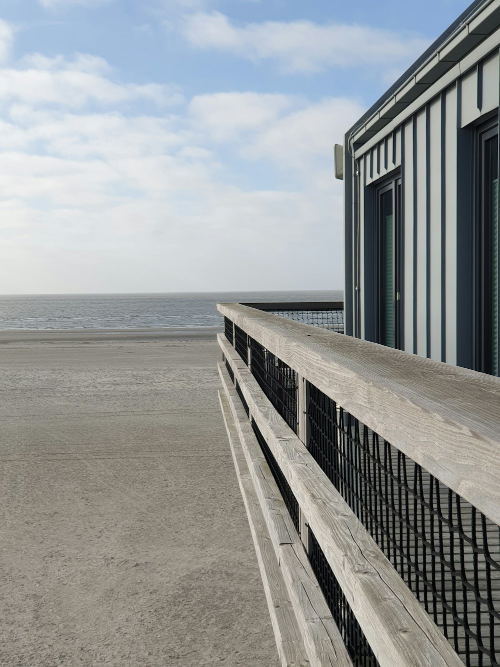 a wooden bench sitting on top of a sandy beach