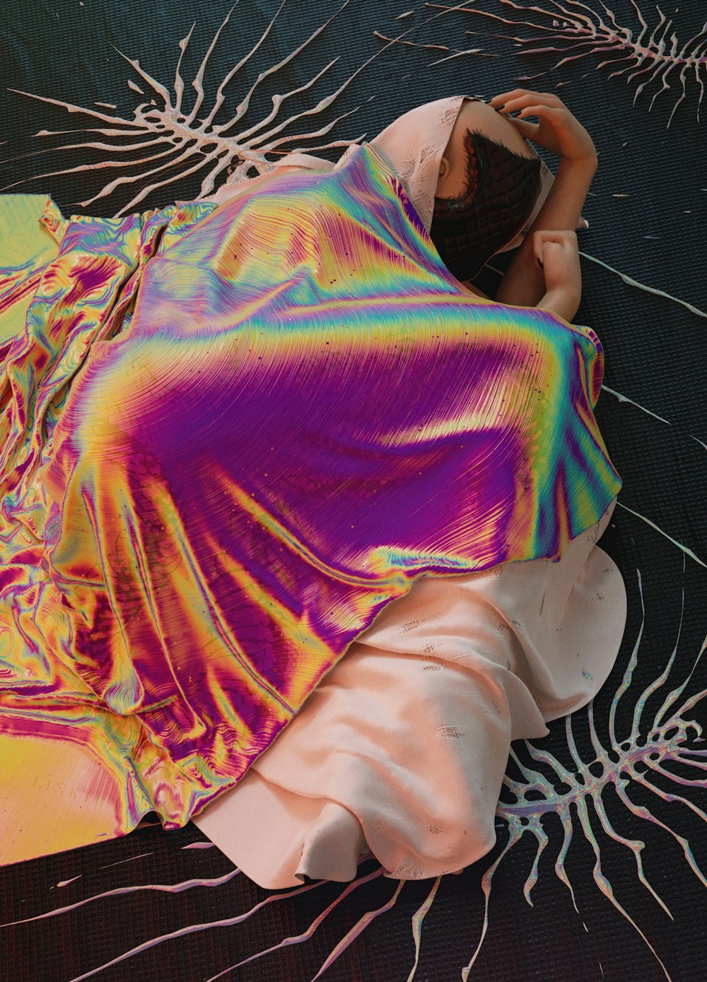 a woman laying on a bed covered in a colorful blanket