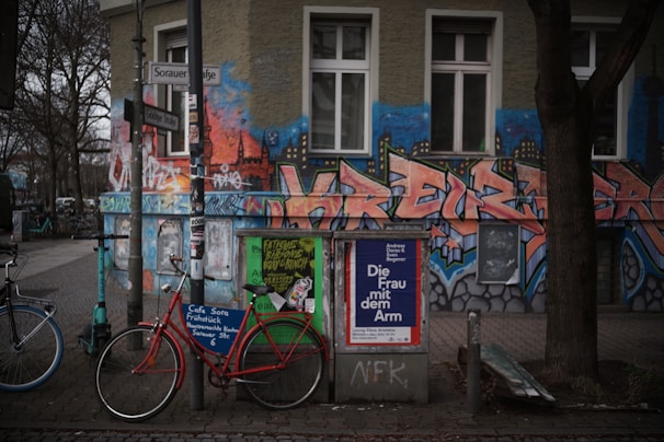 A street scene adorned with large-scale artworks blending text and visuals.