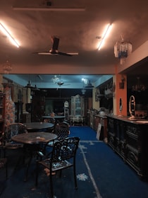 A dimly lit room showcasing noble artifacts, old portraits, and antique furniture.