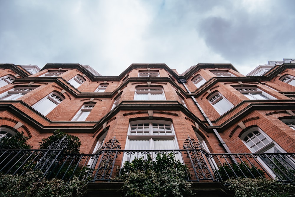 a tall red brick building with lots of windows