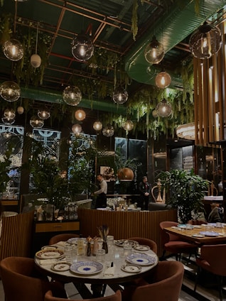 Elegant restaurant interior with natural green leaf accents and minimalist design.