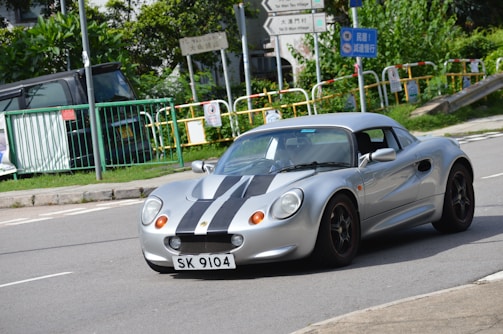 A sleek vintage race car on a winding road.