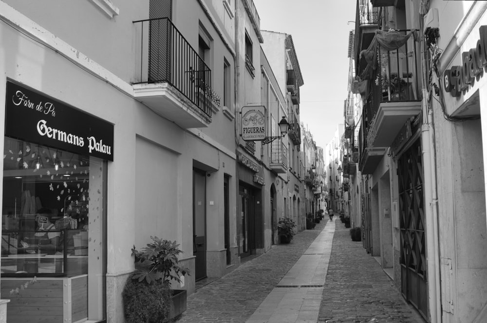 a black and white photo of a narrow street