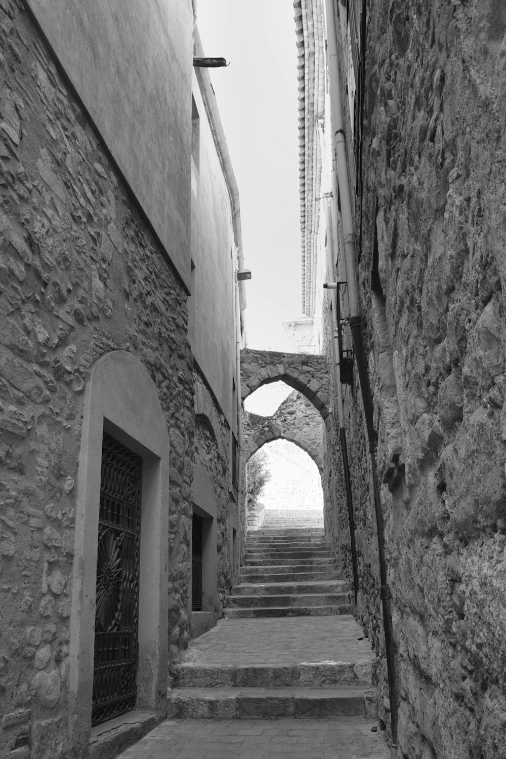 a black and white photo of a narrow street