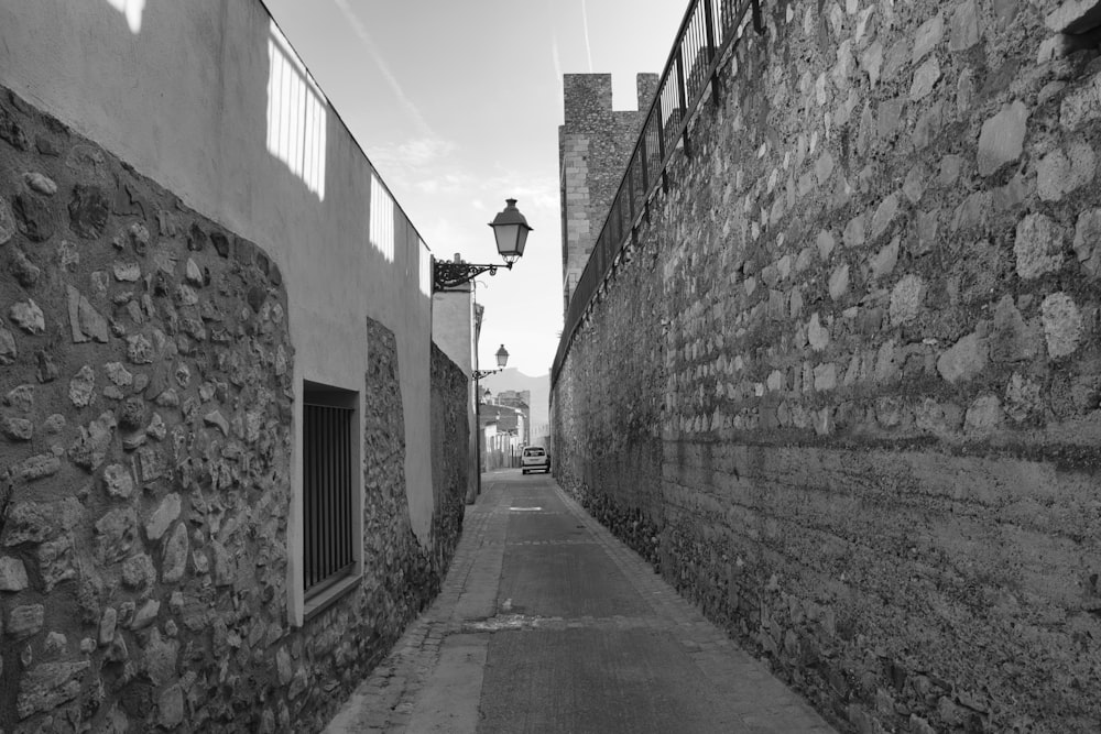 a black and white photo of a narrow street